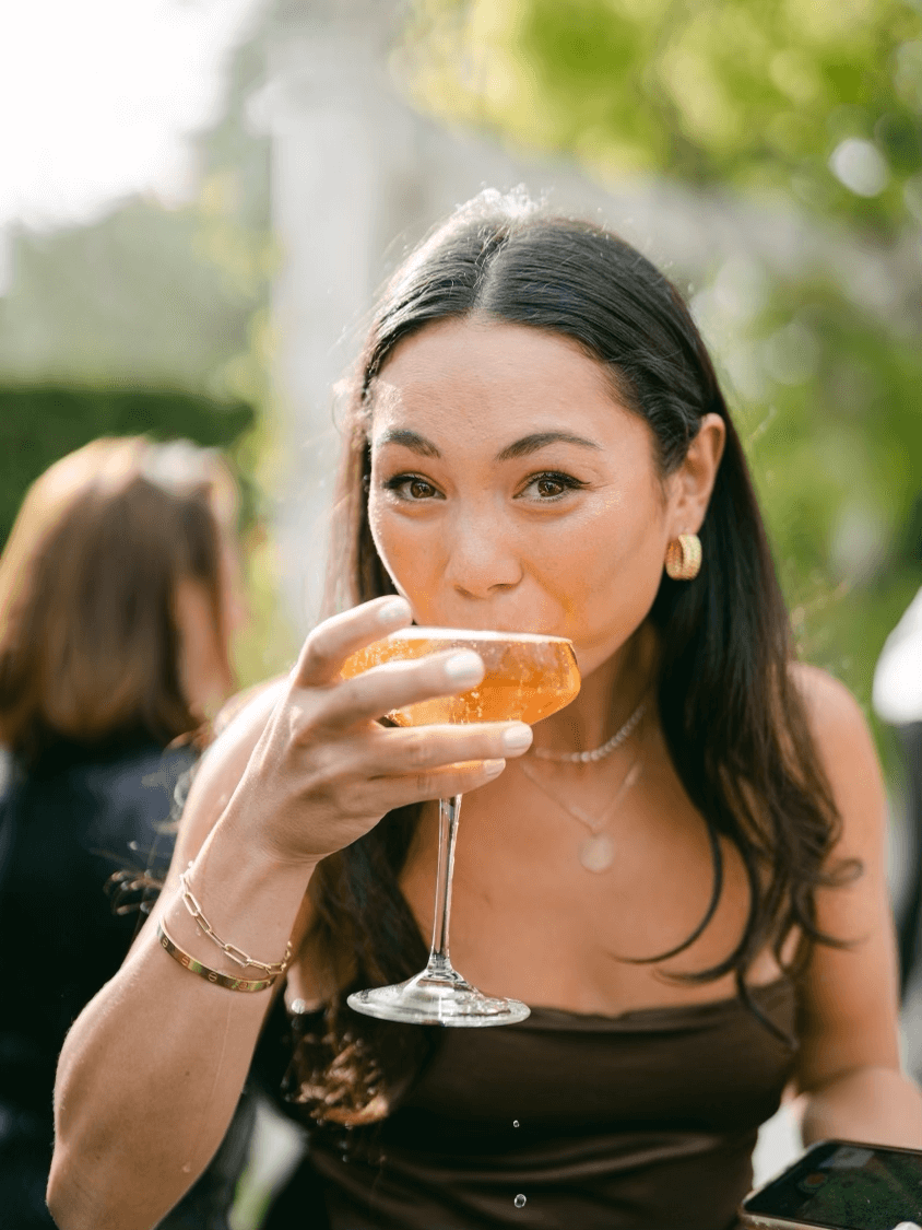 Cate drnking Champagne